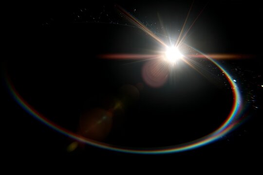 Abstract solar eclipse with lens flare and rainbow light