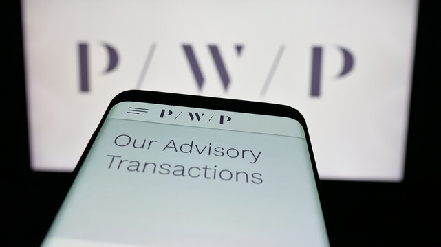 Stuttgart, Germany - 11-19-2025: Mobile phone with website of US company Perella Weinberg Partners (PWP) on screen in front of logo. Focus on top-left of phone display.