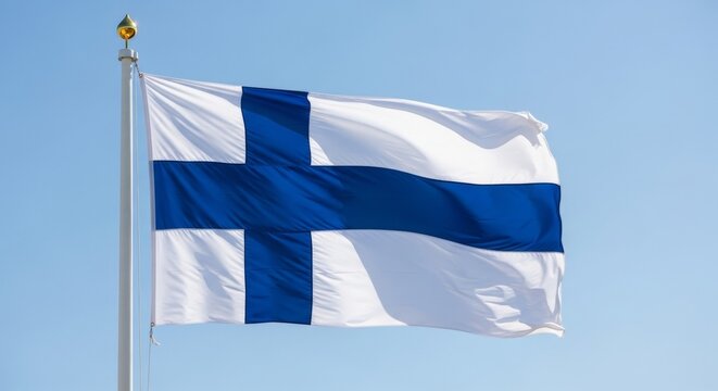 Waving flag of finland with blue nordic cross against clear blue sky