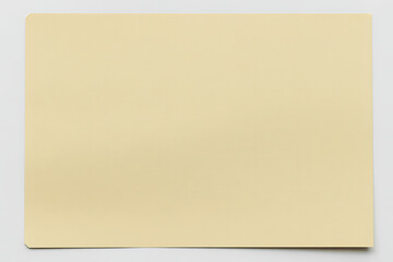 A plain, pale yellow sticky note is centered on a clean white background, ready for a message