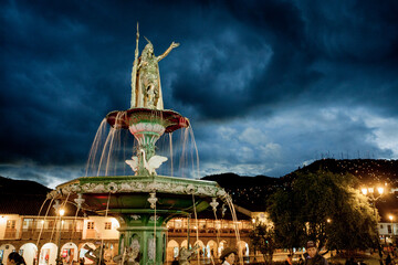 Tupac Amaru II statue at night in ancient city of Cuzco in Peru, with traditional architecture around