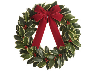 Christmas holly wreath with red velvet bow isolated on transparent background