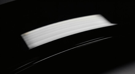 Elegant white stripes on a glossy surface offer a modern, minimalist vibe perfect for professional designs or artistic backgrounds, conveying sleekness and style