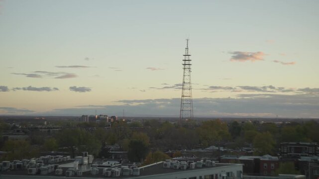 Television Transmission Lattice Tower At Dusk With Industrial Building In The Foreground In Westmount, Montreal, Canada. - wide shot