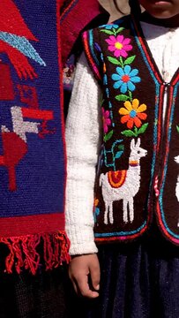 Close up of traditional Andean textiles and embroidered clothing.