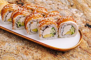 Delicious sushi rolls served on a simple white plate in a restaurant setting