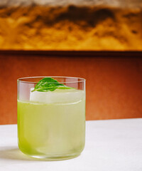 Refreshing green cocktail served in a glass at a bar setting