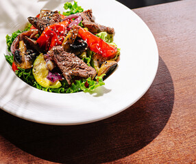 Fresh salad with grilled beef and colorful vegetables served in a bowl