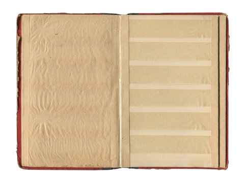 front view of old open vintage photo album with red cover and antique beige pages isolated on white