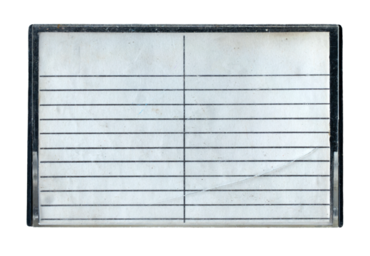 Isolated vintage cracked plastic cassette tape case with lined paper