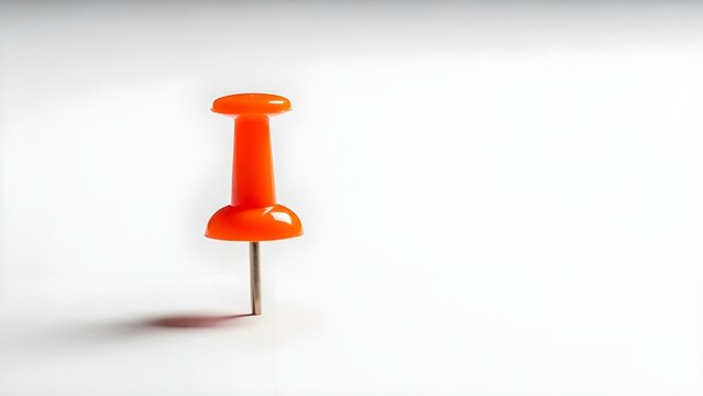 Single Orange Pushpin or Thumbtack Stuck on Minimalist White Background