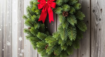 Festive christmas wreath with red bow and pinecones on wooden wall