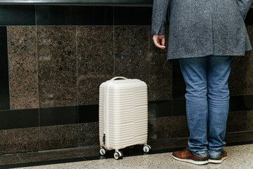 Man standing next to a suitcase
