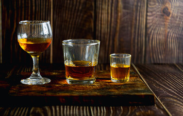 Strong alcohol drink. Whisky in glass, Whisky, bourbon or cognac. Hard strong alcoholic drinkIn various glass forms