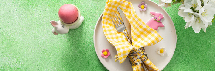 A vibrant Easter table setting features yellow checkered napkins wrapped with twine, a decorative plate, and fresh flowers, creating a festive atmosphere for spring gatherings, banner