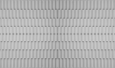 a wall covered in uniformly spaced, vertically aligned, rectangular white tiles. The tiles have a slight shadow between each, creating a textured, three-dimensional appearance