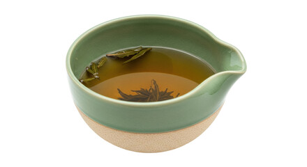 Isolated close-up studio shot of herbal tea in green ceramic cup with pouring spout studio