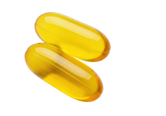 Isolated Two golden, yellow Omega-3 softgel capsules in a pile for dietary supplements