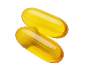 Isolated Two golden, yellow Omega-3 softgel capsules in a pile for dietary supplements
