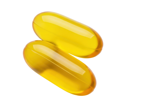 Isolated Two golden, yellow Omega-3 softgel capsules in a pile for dietary supplements
