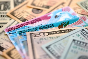 American US dollars money bills with permanent resident and employment authorization card close up