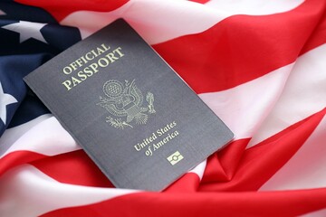 United States official passport book on US flag close up. Travel document on official banner photo