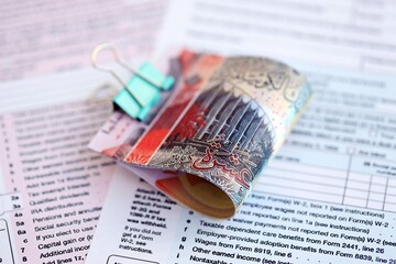 Kuwaiti dinar money bills on tax form close up. Taxation and accounting concept