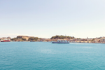 Fototapeta premium The picturesque waterfront and port of a Mediterranean town on Corfu island, Greece.