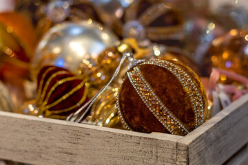Close-up of brown and gold festive Christmas decorations in wooden box