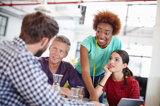 Fashion designer, team and meeting with discussion in office for creative ideas, feedback or planning. Clothing production, people or happy with chat in startup for brand development or brainstorming