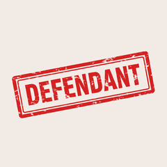 A red grunge rubber stamp with the word "DEFENDANT" on a light background, indicating a legal or court context.