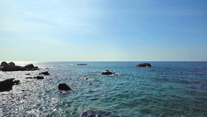 Longtail boat navigating clear blue sea near Ko Tao Island, Surat Thani, Thailand, Southeast Asia.