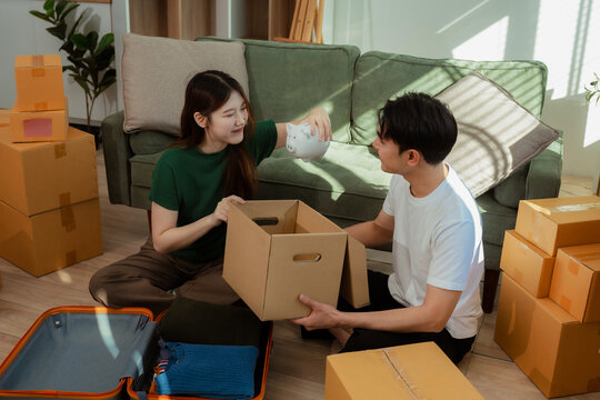 young couple helps put things in boxes and prepares to move to a new house.