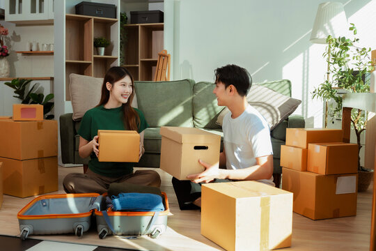 young couple helps put things in boxes and prepares to move to a new house.