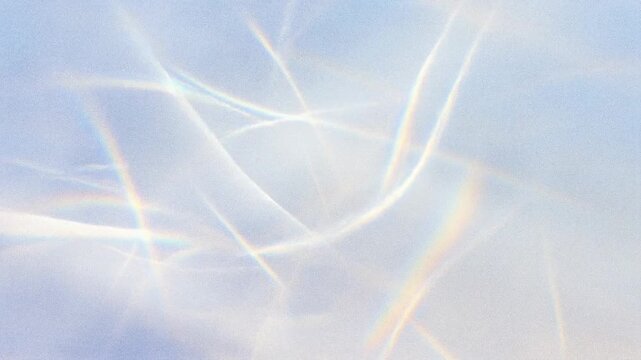 Abstract light patterns with soft pastel colors and rainbow reflections.