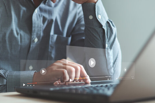 Businessman working on laptop computer, watching video player, webinar, business online training, education on computer or e-learning concept, video tutorial, learn from home, telework concept.