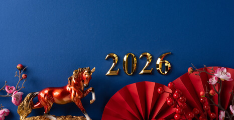 A festive display featuring a golden horse statue, red fans, and blossoms to celebrate the 2026 Chinese New Year with vibrant decor and traditional symbolism