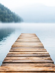 Fototapeta premium Calm Wooden Pier Overlooking Foggy Lake in Serene Landscape