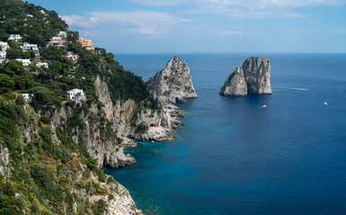 Fototapeta premium Capri, Italy - 04.29.2025: Scenic view from a high viewpoint of the island of Capri with houses and the sea.