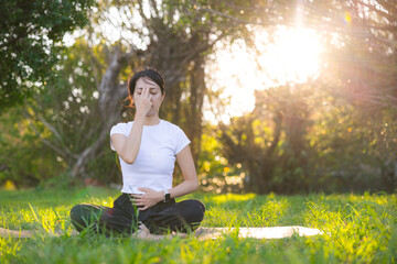 Woman practicing pranayama breathing exercises at park