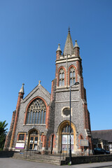 Methodist Church Building with Tall Steeple and Stained Glass Window Under Clear Blue Sky, Petersfield