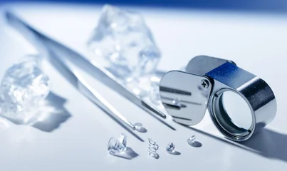 Fototapete Rund Minecraft Closeup of diamonds and jewelers tools: gemstones, loupe, and tweezers on a white surface  © Parilov