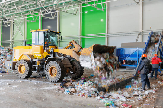 Industrial waste recycling facility with machinery and workers