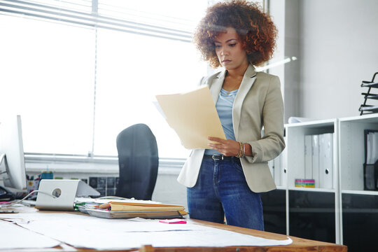 Business woman, administrator and review with folder for company tax, finance or report in office. Female person, employee or admin with documents or file for backlog, expenses or financial records