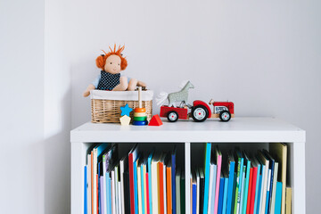 Details of interior decor of children's room with empty white wall. Organizing storage in child's...