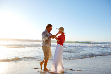 Love, mature couple and dancing on beach for anniversary date, travel adventure or weekend break. Happy, people or holding hands with movement at seaside for romantic holiday, bonding or mockup space
