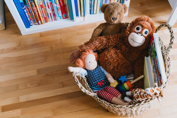 Interior decor of children's room with basket full of toys and book corner of child's literature....