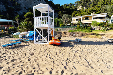 Lifeguard tower and beach resort on a sandy Mediterranean coast