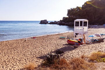Lifeguard tower and beach resort on a sandy Mediterranean coast