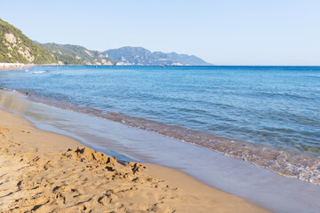 Tranquil seascape view of sandy beach and distant rugged coastline
